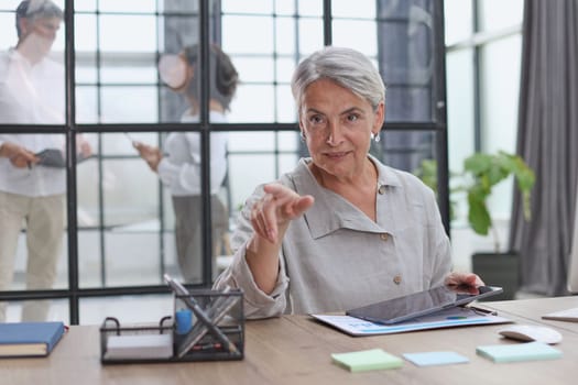 Modern mature businesswoman working at her desk