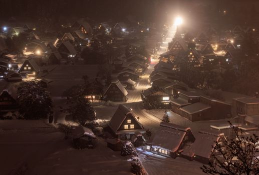 Bright Light at the End of the Main Street in Shirakawa-go on a Snowy Night. High quality photo