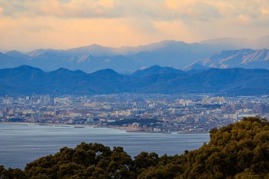 Beautiful Sunset Color in Sky Over Mountains and Sprawling City on Coast. High quality photo