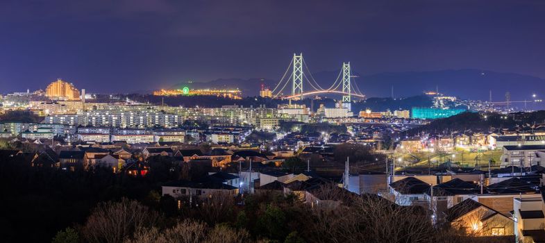 Panoramic View of in Residential Suburb and Suspension Bridge at Night. High quality photo