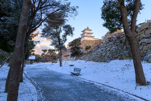 Path in snow through Akashi Castle Park on quiet winter morning. High quality photo