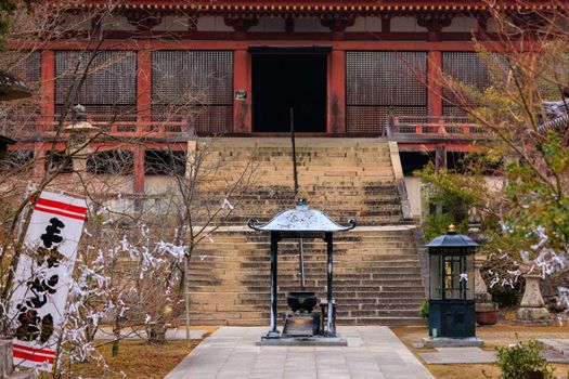 Incense burner and stairs leading to entrance of historic Japanese shrine. High quality photo