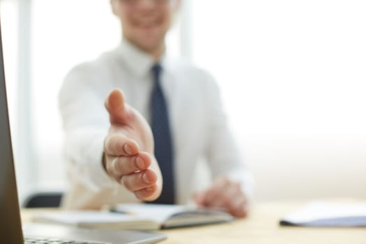 Smiling businessman pleased to meet you at office