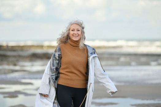 Portrait of a fifty-year-old woman with a white smile