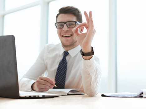 business, startup, gesture and people concept - happy businessman or creative male office worker with computers showing ok hand sign