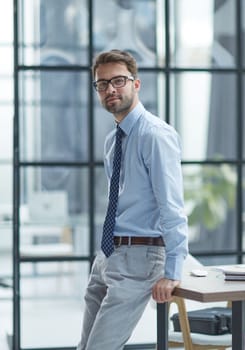 Young cheerful businessman working at office