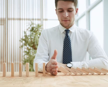 Businessman with dominoes in the office