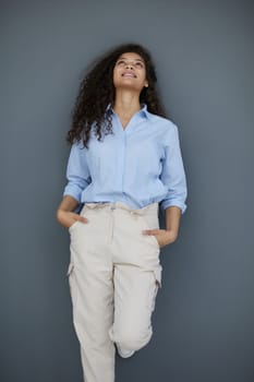 Photo of cheerful self-assured lady folded arms wear blue shirt grey color background