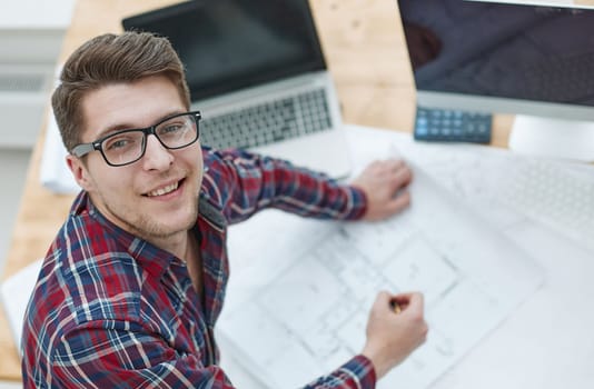 Architect working on drawing table in office. top wiew