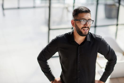 Businessman portrait. Happy confident young businessman standing , smiling, looking at camera.
