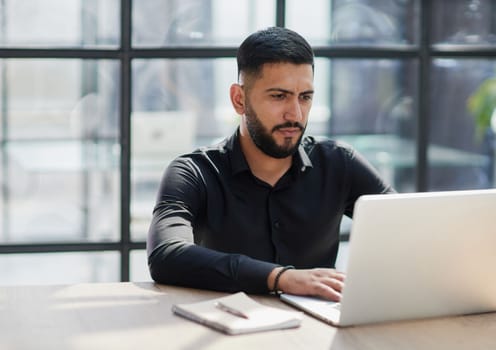 Bearded young businessman working on modern office.