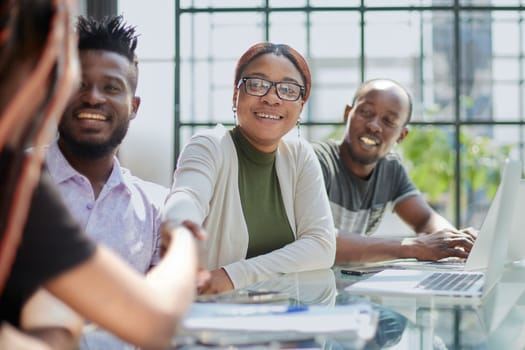 african business people handshaking at modern office