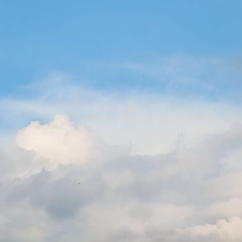 Background of blue sky with white clouds. Natural backdrop