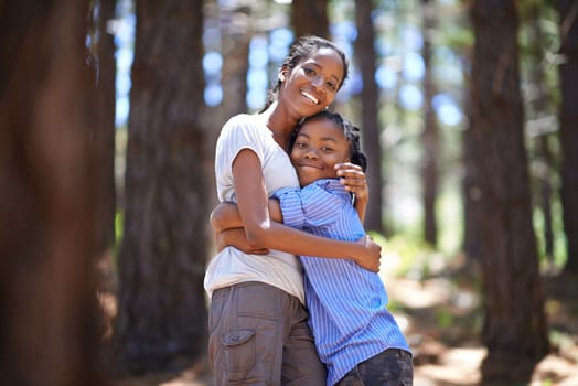 We love the outdoors and each other. Portrait of a mother and son embracing while enjoying a day outdoors