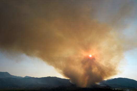 Photographic documentation of a large column of smoke caused by a forest fire in the upper Versilia Tuscany