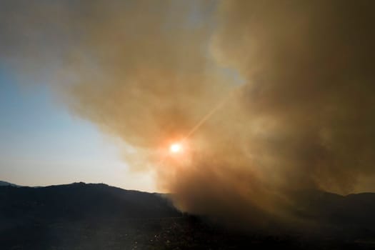 Photographic documentation of a large column of smoke caused by a forest fire in the upper Versilia Tuscany