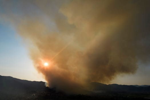 Photographic documentation of a large column of smoke caused by a forest fire in the upper Versilia Tuscany