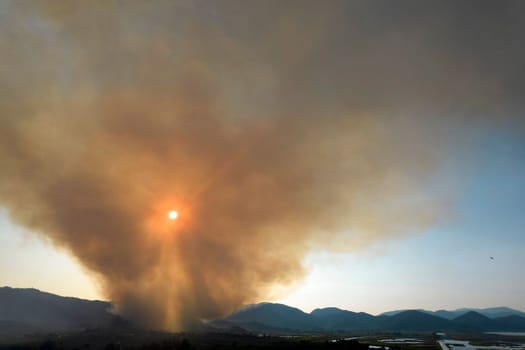 Photographic documentation of a large column of smoke caused by a forest fire in the upper Versilia Tuscany