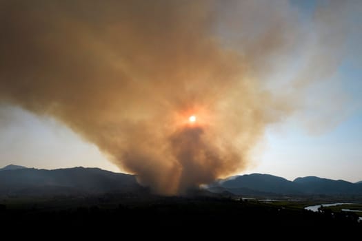 Photographic documentation of a large column of smoke caused by a forest fire in the upper Versilia Tuscany