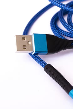 Blue wire to connect the device on white background close up