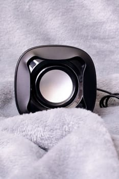 Two small speakers on a gray background close up