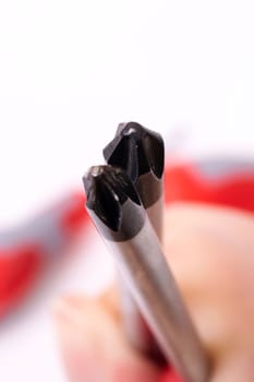 Screwdrivers in hand on a white background close up