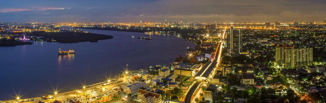 Panorama Street lights and lights from residential homes in the suburbs during sunset time, boat traffic Vehicle traffic in Samut Prakan, Thailand