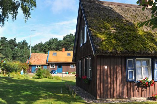 old old wooden house, red, in the European country of Lithuania, in the spa town of Nida, on the Curonian Spit