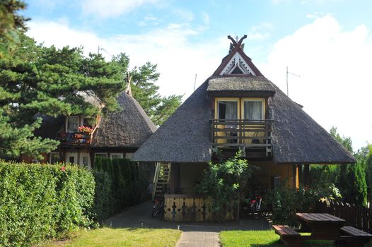 old old wooden house, red, in the European country of Lithuania, in the spa town of Nida, on the Curonian Spit.