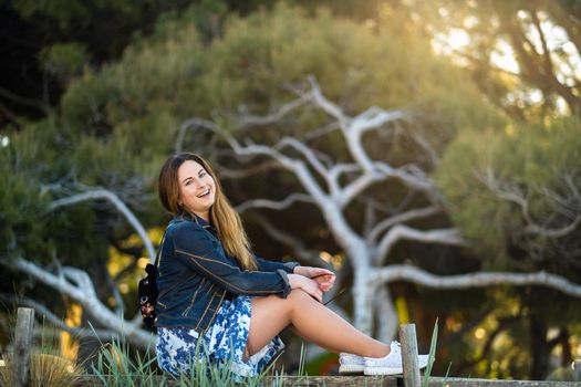 Portrait of a girl in a skirt on the embankment of the village of Saint-Cyr-sur-Mer, France.