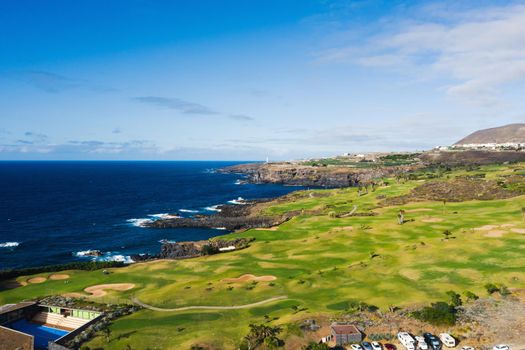 Golf course near the Atlantic ocean in Tenerife, Spain, green Golf course, tennis court in the nature of Tenerife.