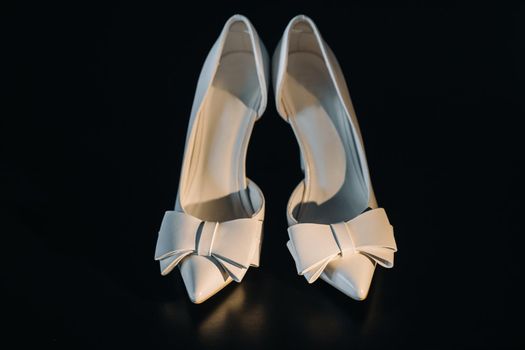 white wedding shoes on a black background.