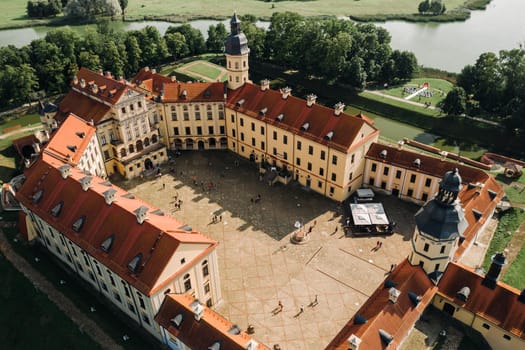 Aerial photo Nesvizh castle in autumn evening, Belarus Minsk, top view.