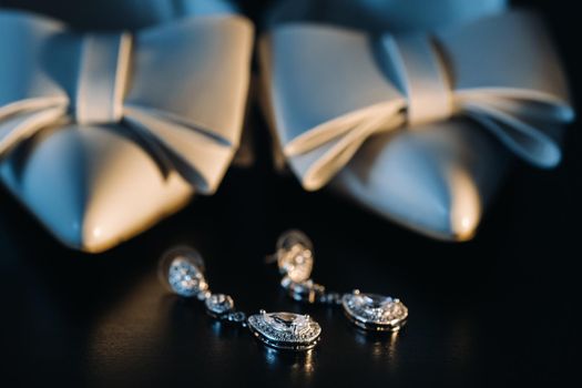 Accessories for the bride. Wedding Earrings on a black background..