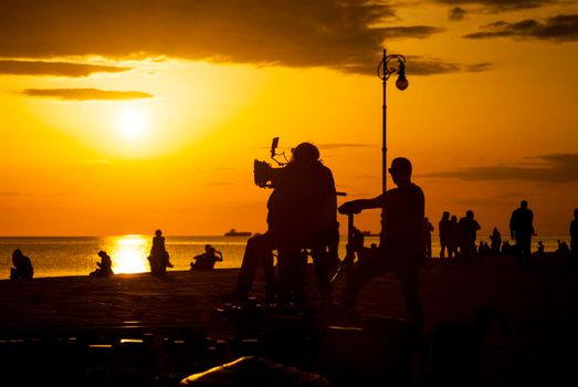 TRIESTE, ITALY - APRIL, 17: Behind the scene. Film crew team filming movie scene on outdoor location at sunset on April 17, 2018