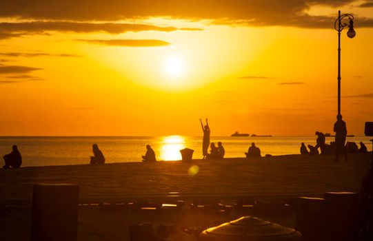 TRIESTE, ITALY - APRIL, 17: Behind the scene. Film crew team filming movie scene on outdoor location at sunset on April 17, 2018