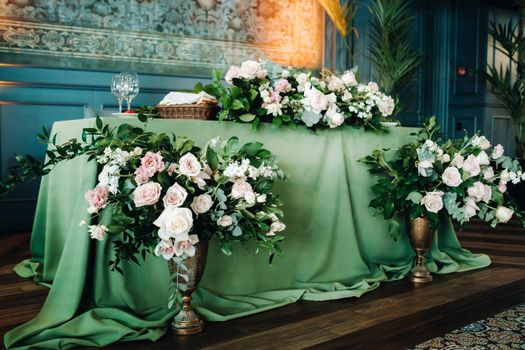 wedding table decoration with flowers on the table in the castle, table decor for dinner by candlelight.Dinner with candles.