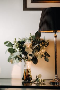 wedding bouquet with roses and boutonniere.The decor at the wedding.