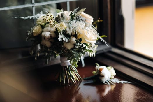 wedding bouquet with roses and boutonniere.The decor at the wedding.