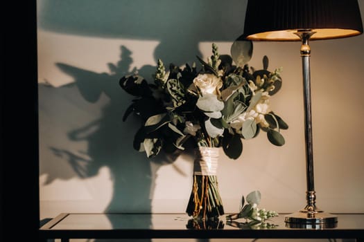 wedding bouquet with roses and boutonniere.The decor at the wedding.