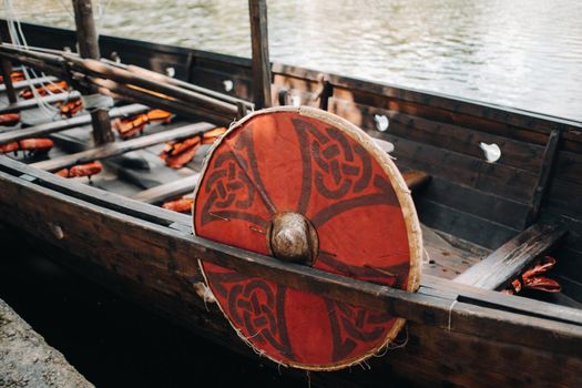 An antique Viking ship on the river. Old boat.