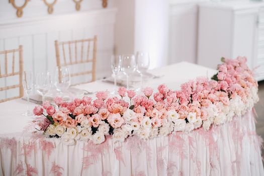 wedding table decoration with flowers on the table in the castle, table decor for dinner by candlelight.Dinner with candles.