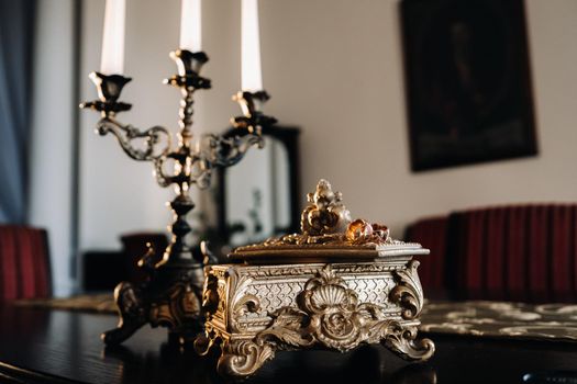 Gold wedding rings lie on an antique jewelry box. Wedding rings for ceremonies.