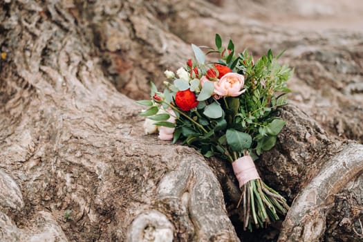 wedding bouquet with roses and boutonniere.The decor at the wedding.