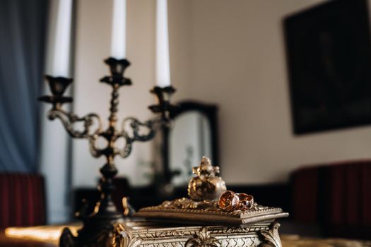 Gold wedding rings lie on an antique jewelry box. Wedding rings for ceremonies.