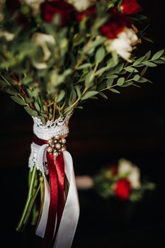 wedding bouquet with roses and boutonniere.The decor at the wedding.