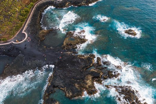 Rough rocky cliffs in the North of Tenerife.Black beach in the Canary Islands. Rocks, volcanic rocks, Atlantic ocean.