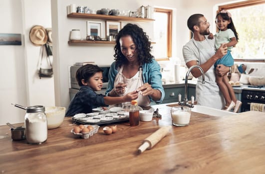 A dysfunctional family is any family with more than one person in it. a young couple baking at home with their two children