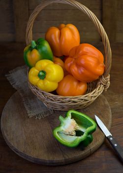 colored peppers on wooden board