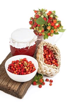 strawberry branches, jam on a wooden board isolated on the white